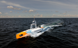 Oceanus12 autonomous uncrewed surface vessel (USV) transiting at speed across open sea, demonstrating autonomous maritime operations and advanced navigation capabilities.