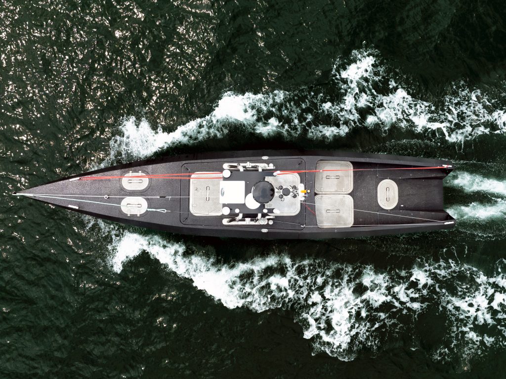 Aerial view of the Oceanus12 autonomous surface vessel underway at sea, showcasing its uncrewed design and advanced AI-powered maritime autonomy platform.
