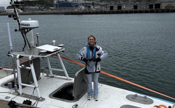 Marine AI team member working aboard an autonomous vessel during harbour operations