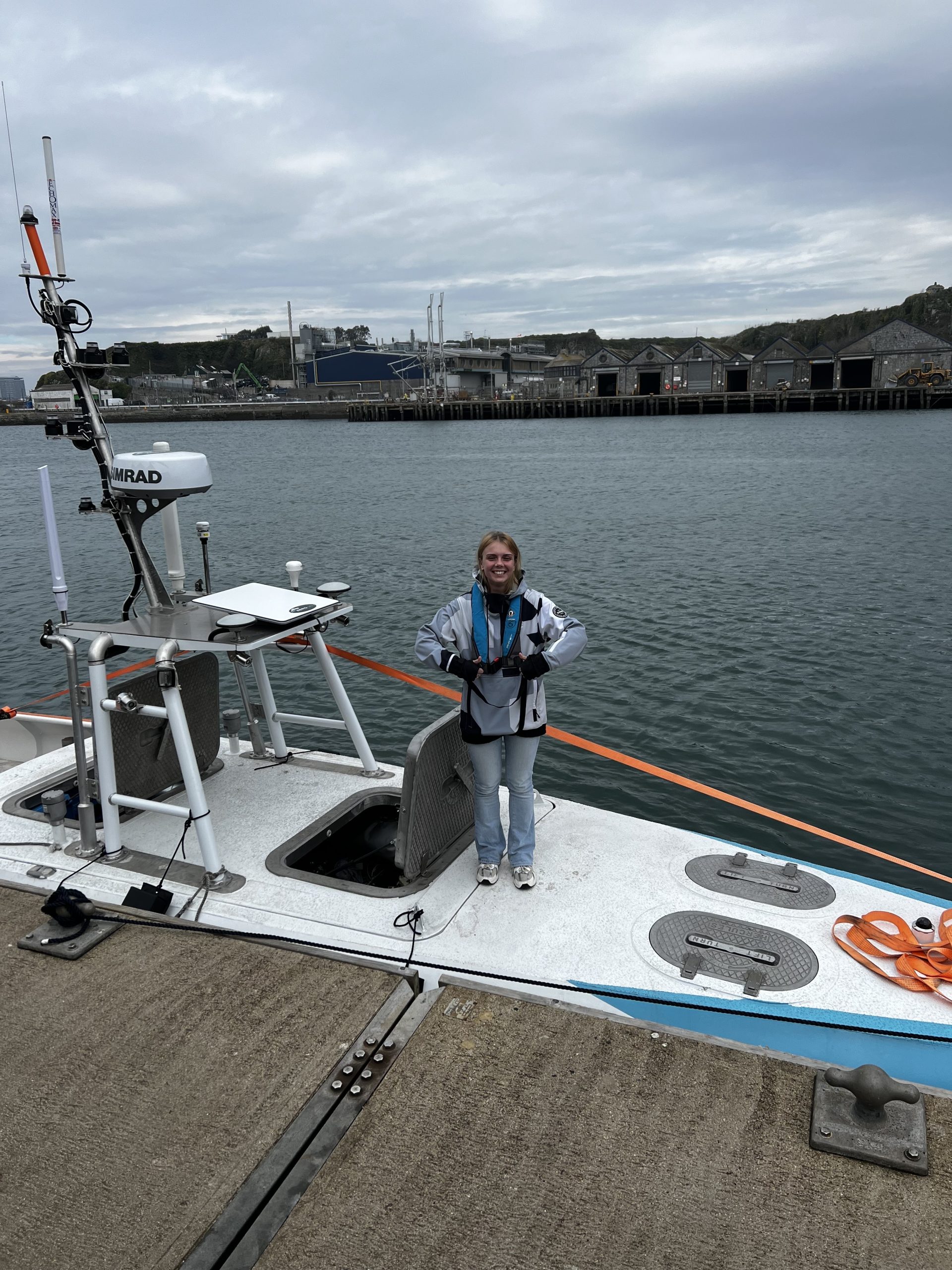 Marine AI team member working aboard an autonomous vessel during harbour operations